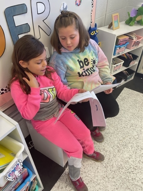 Two students reading to each other