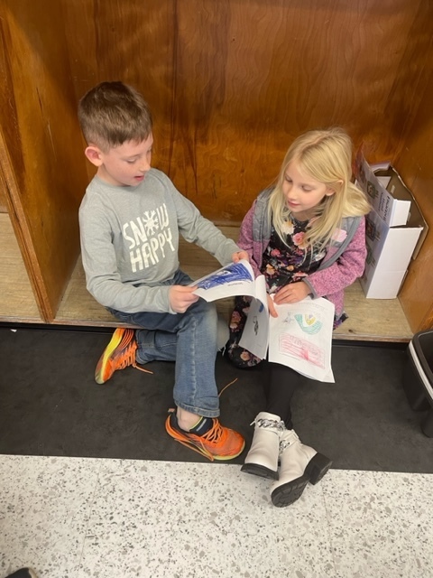 Two students reading to each other
