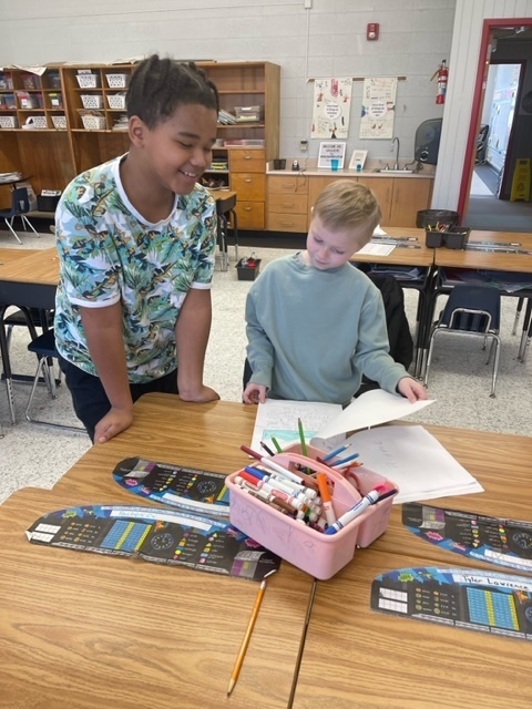 2 students sharing work at desk