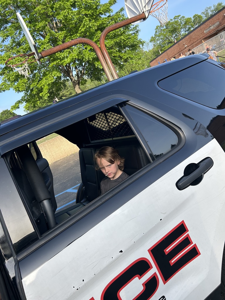 student checking out a police vehicle